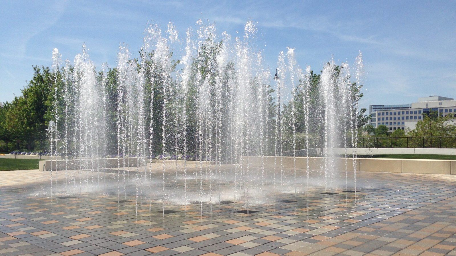 Water fountain jets in a sunny public plaza
